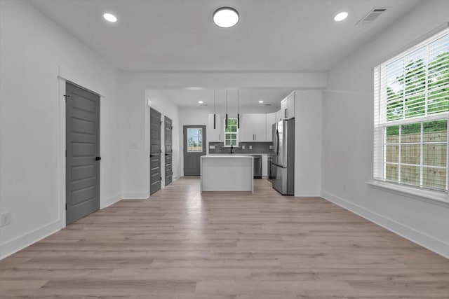 1017 Miller St, Augusta, GA 30901 - kitchen with stainless steel appliances, open floor plan, white cabinetry, light wood-type flooring, and a center island