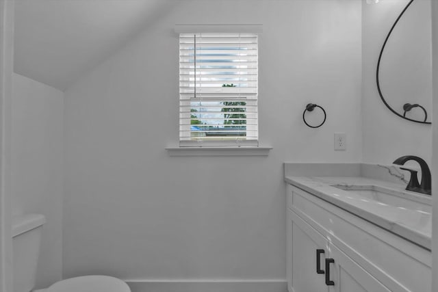 1017 Miller St, Augusta, GA 30901 - half bathroom with vaulted ceiling, vanity, toilet, and baseboards