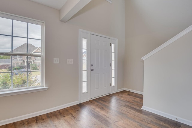 foyer entrance with beam ceiling and dark hardwood / wood-style flooring