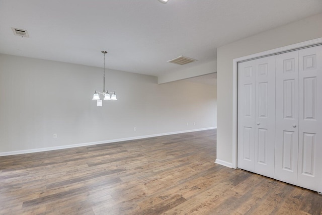 interior space with dark wood-type flooring and a chandelier