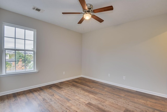 empty room with dark hardwood / wood-style floors and ceiling fan