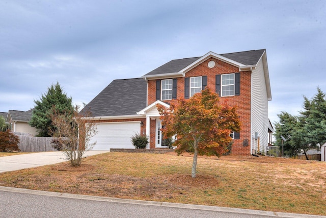 colonial home featuring a front yard and a garage