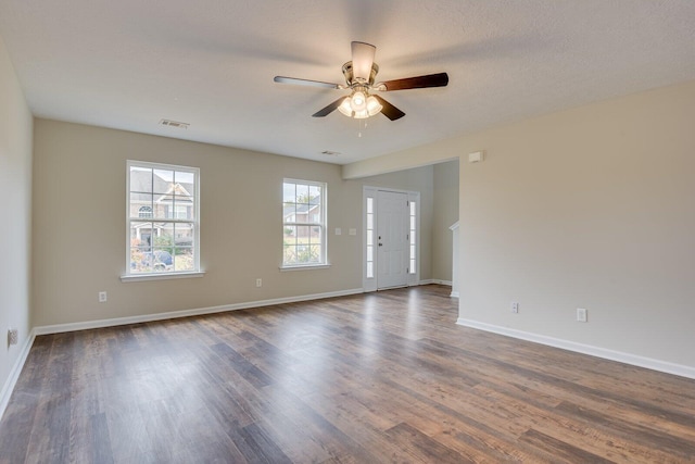 spare room with dark hardwood / wood-style floors and ceiling fan