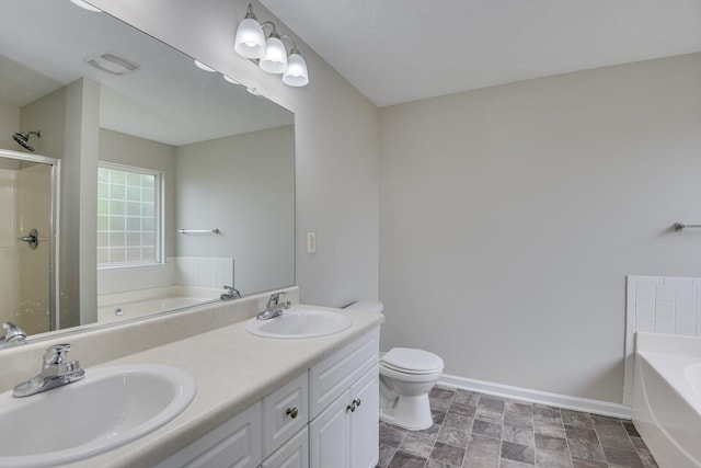 bathroom featuring vanity, toilet, and a tub