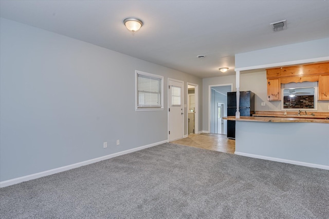 2009 Brighton Cir, Augusta, GA 30906 - kitchen with freestanding refrigerator, light colored carpet, and light countertops