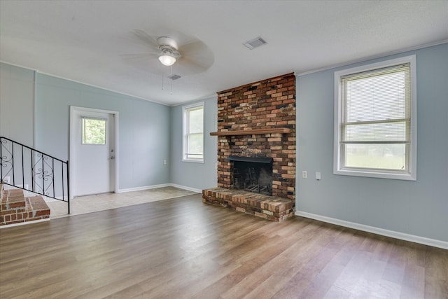2009 Brighton Cir, Augusta, GA 30906 - unfurnished living room featuring wood finished floors, ceiling fan, stairs, ornamental molding, and a fireplace
