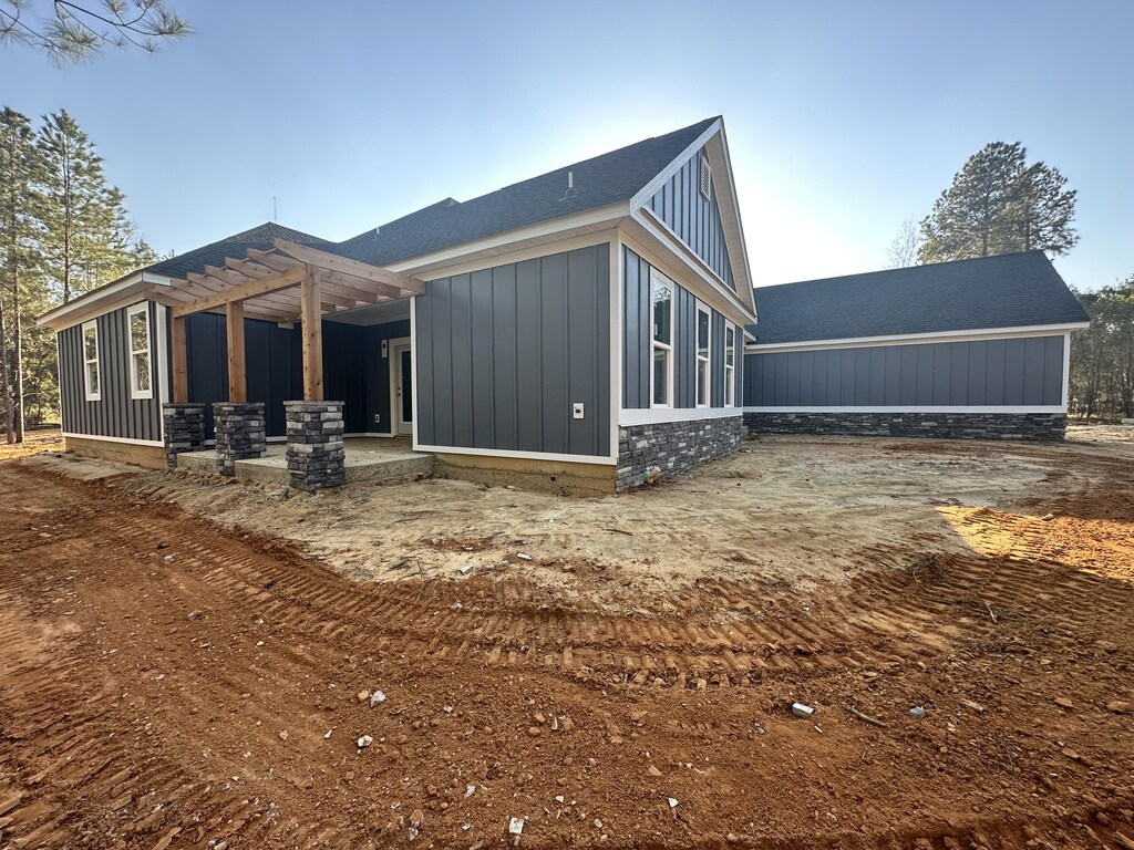 community pool with fence, a wooded view, and a patio