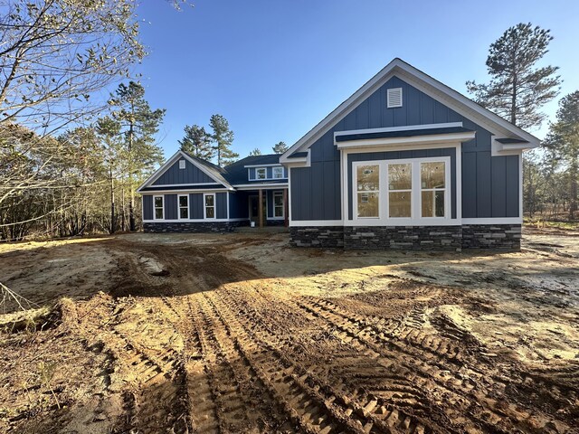 rear view of house featuring board and batten siding