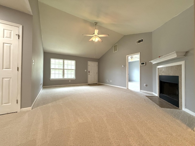 1420 Sawmill Trl, Grovetown, GA 30813 - unfurnished living room with carpet, ceiling fan, baseboards, a tiled fireplace, and high vaulted ceiling