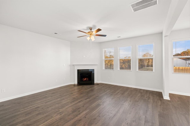 unfurnished living room featuring dark hardwood / wood-style floors and ceiling fan