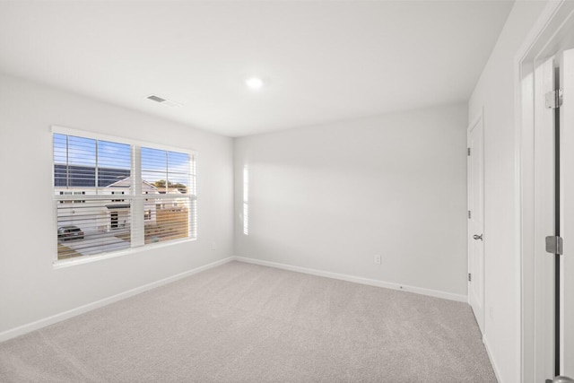 empty room featuring light colored carpet