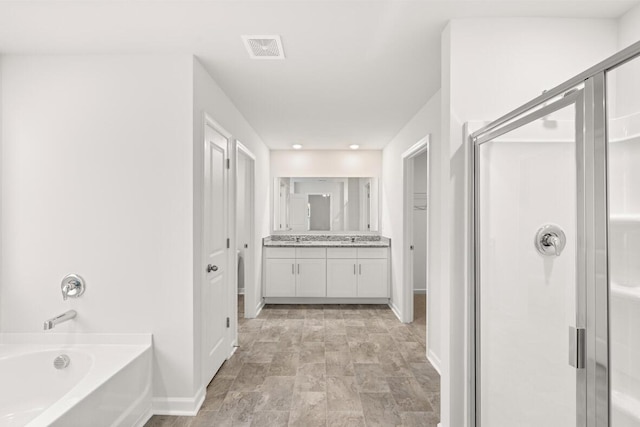 bathroom with separate shower and tub and vanity