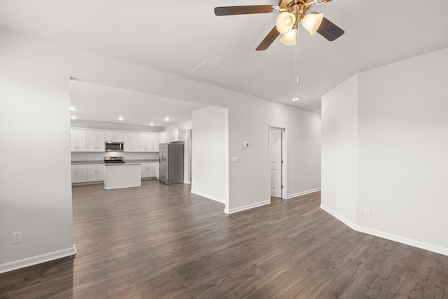 unfurnished living room with ceiling fan and dark wood-type flooring