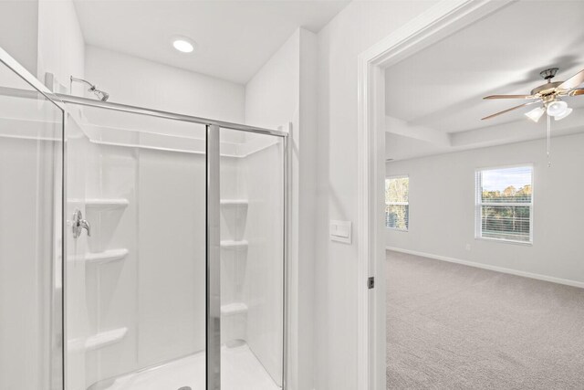 bathroom featuring ceiling fan and a shower with door