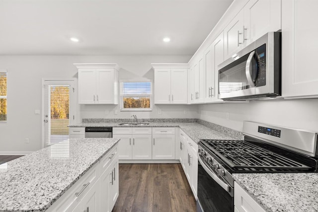 kitchen featuring dark hardwood / wood-style flooring, sink, white cabinetry, and stainless steel appliances