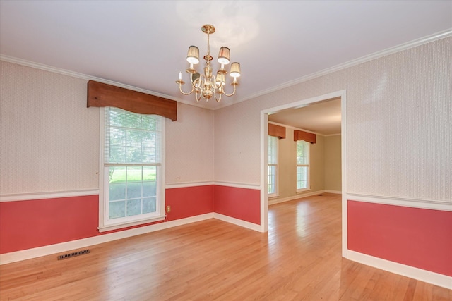 413 Mcintosh Dr, Waynesboro, GA 30830 - spare room with wallpapered walls, crown molding, a chandelier, light wood-style flooring, and baseboards