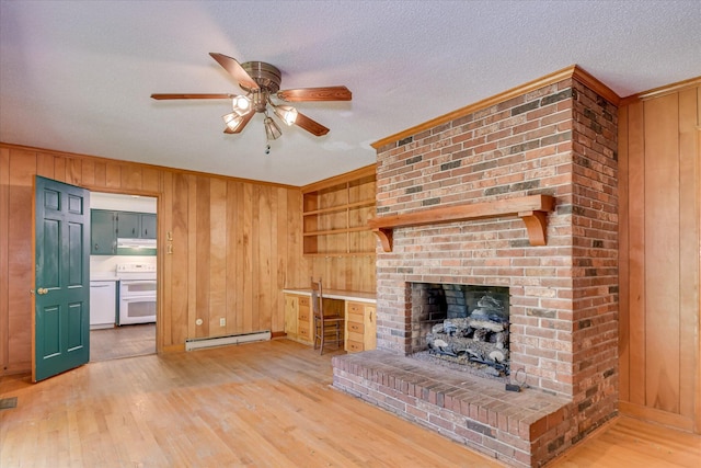 413 Mcintosh Dr, Waynesboro, GA 30830 - unfurnished living room featuring baseboard heating, wooden walls, light wood-type flooring, ceiling fan, and crown molding