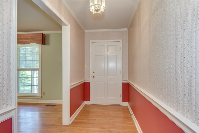 413 Mcintosh Dr, Waynesboro, GA 30830 - corridor with wallpapered walls, light wood-style flooring, crown molding, baseboards, and a chandelier
