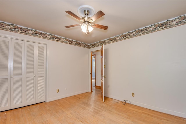 413 Mcintosh Dr, Waynesboro, GA 30830 - unfurnished bedroom with wood finished floors, baseboards, a closet, and a ceiling fan