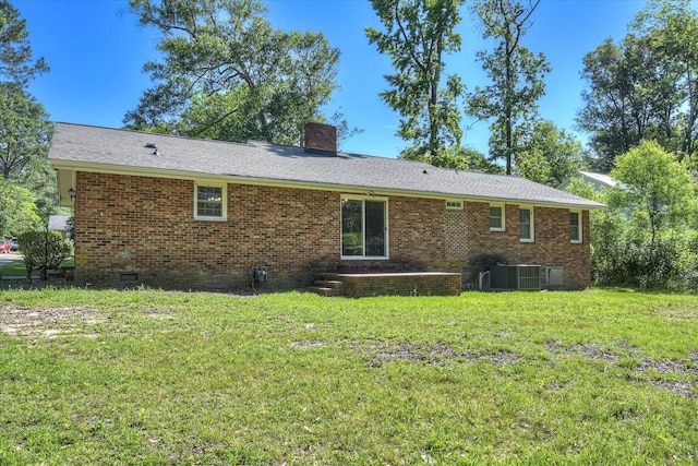 413 Mcintosh Dr, Waynesboro, GA 30830 - rear view of property with brick siding, a lawn, a chimney, central air condition unit, and crawl space