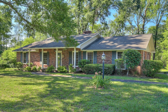 413 Mcintosh Dr, Waynesboro, GA 30830 - single story home featuring brick siding, a chimney, a front lawn, a porch, and a shingled roof