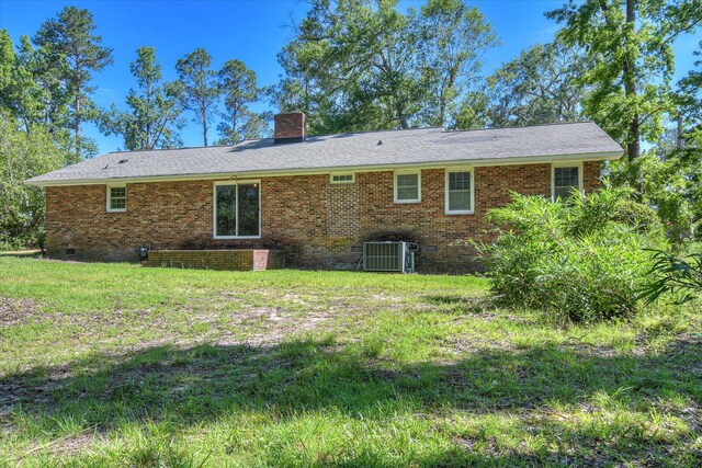 413 Mcintosh Dr, Waynesboro, GA 30830 - back of property with a chimney, brick siding, central AC unit, a lawn, and crawl space