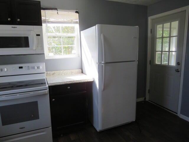 kitchen with light countertops, white appliances, and dark wood-style flooring