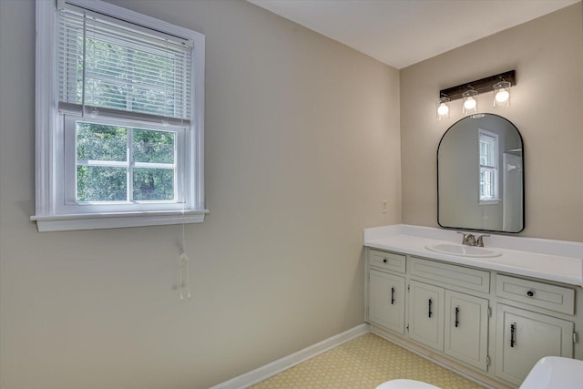 bathroom featuring vanity, toilet, and a wealth of natural light