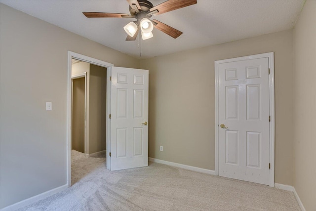 unfurnished bedroom with ceiling fan and light carpet