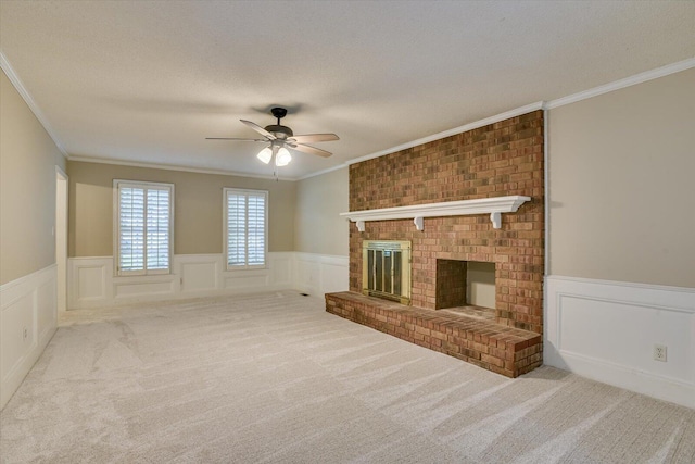 unfurnished living room with a fireplace, light carpet, a textured ceiling, and ornamental molding