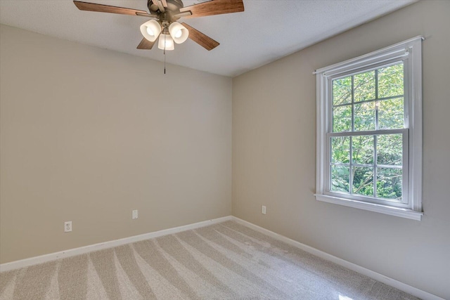 empty room featuring carpet flooring and ceiling fan