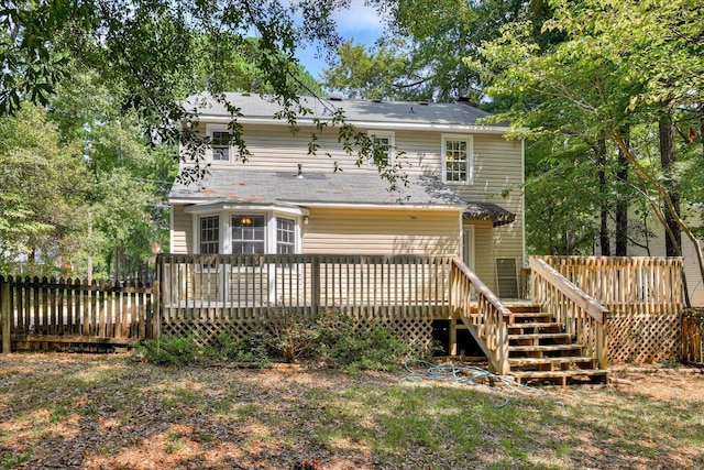 rear view of property with a wooden deck