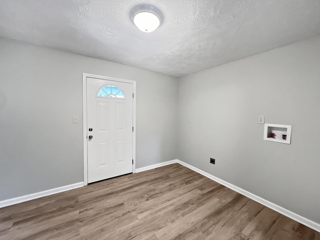 entrance foyer with wood-type flooring and a textured ceiling