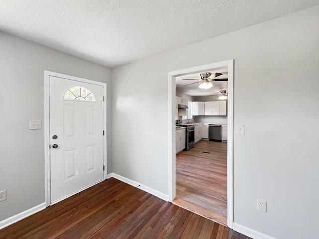 entrance foyer with ceiling fan, hardwood / wood-style floors, and a textured ceiling