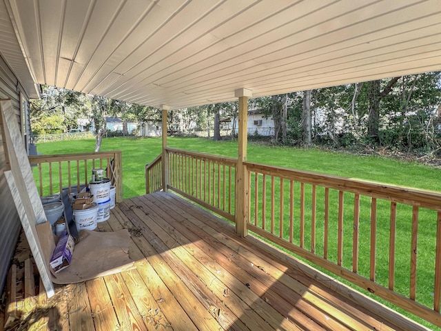 wooden terrace with a lawn