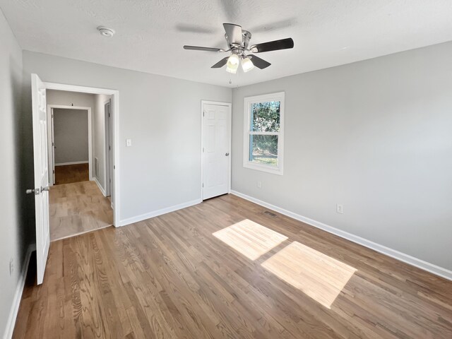 unfurnished bedroom featuring light hardwood / wood-style floors and ceiling fan