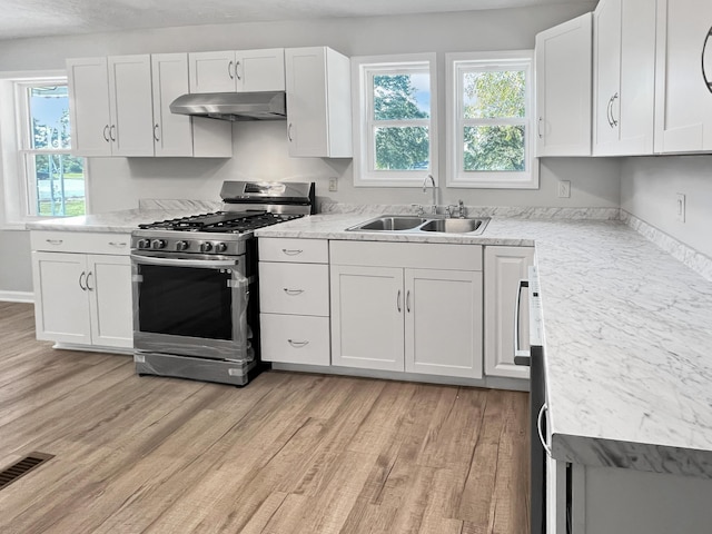 kitchen featuring sink, white cabinets, and stainless steel range with gas stovetop