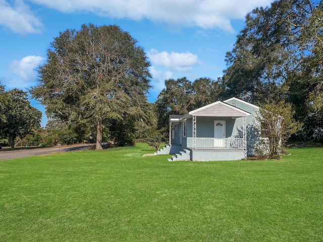 view of yard featuring covered porch