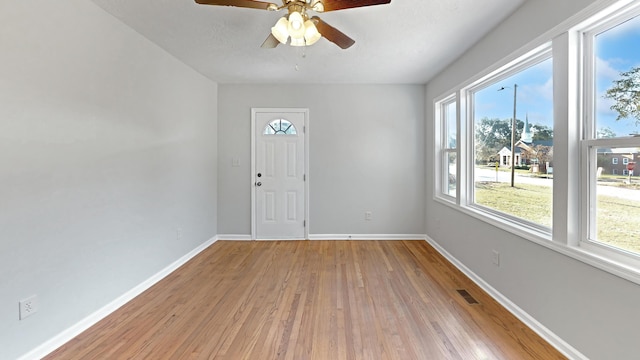 foyer entrance with hardwood / wood-style flooring and ceiling fan