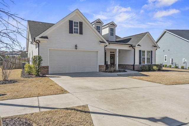 view of front of home featuring a garage and central AC