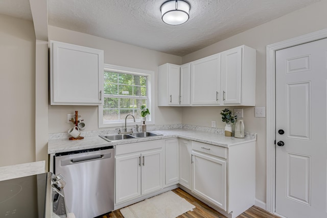 kitchen featuring a textured ceiling, sink, light hardwood / wood-style flooring, dishwasher, and white cabinetry