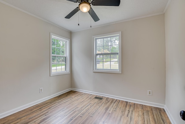 spare room with a textured ceiling, light hardwood / wood-style floors, ceiling fan, and crown molding