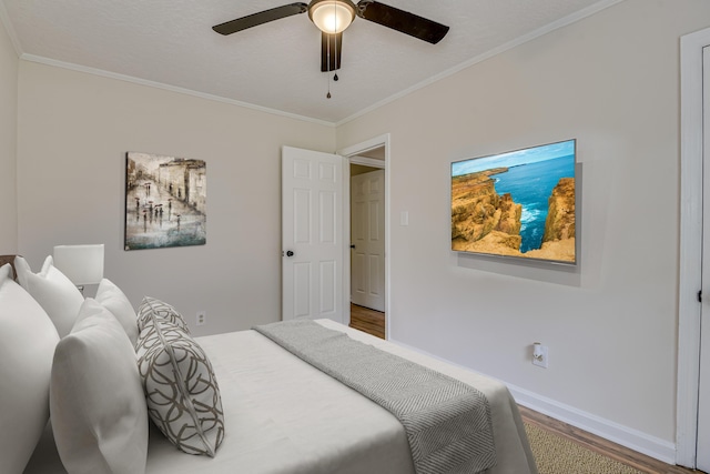 bedroom with hardwood / wood-style flooring, ceiling fan, and crown molding