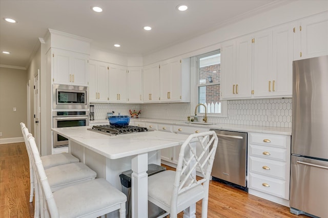 820 Barrett Ln, Augusta, GA 30909 - kitchen with appliances with stainless steel finishes, crown molding, a sink, tasteful backsplash, and white cabinetry