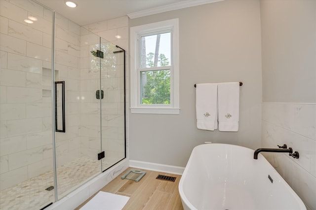 820 Barrett Ln, Augusta, GA 30909 - full bath featuring a shower stall, a freestanding bath, crown molding, baseboards, and wood finished floors