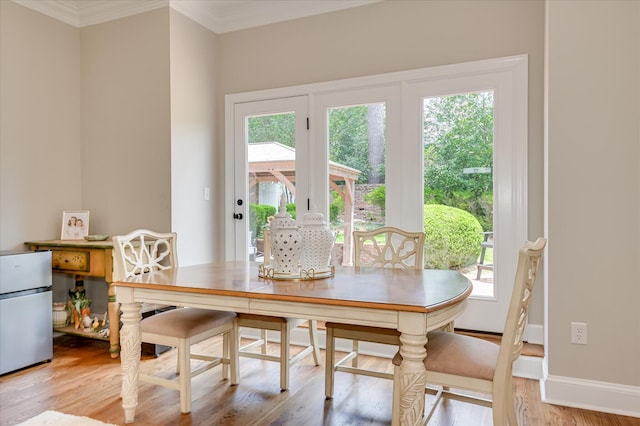 820 Barrett Ln, Augusta, GA 30909 - dining space with healthy amount of natural light, light wood finished floors, and ornamental molding