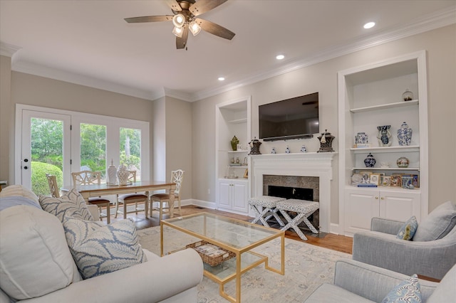 820 Barrett Ln, Augusta, GA 30909 - living area featuring light wood-style floors, a ceiling fan, built in features, baseboards, and a fireplace