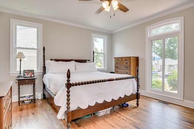 820 Barrett Ln, Augusta, GA 30909 - bedroom featuring light wood-style floors, crown molding, multiple windows, baseboards, and a ceiling fan