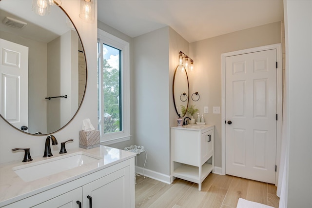 820 Barrett Ln, Augusta, GA 30909 - full bath with two vanities, wood finished floors, and baseboards