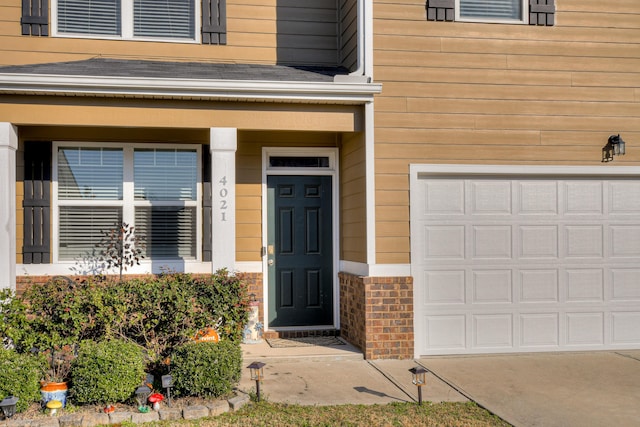 view of exterior entry featuring brick siding